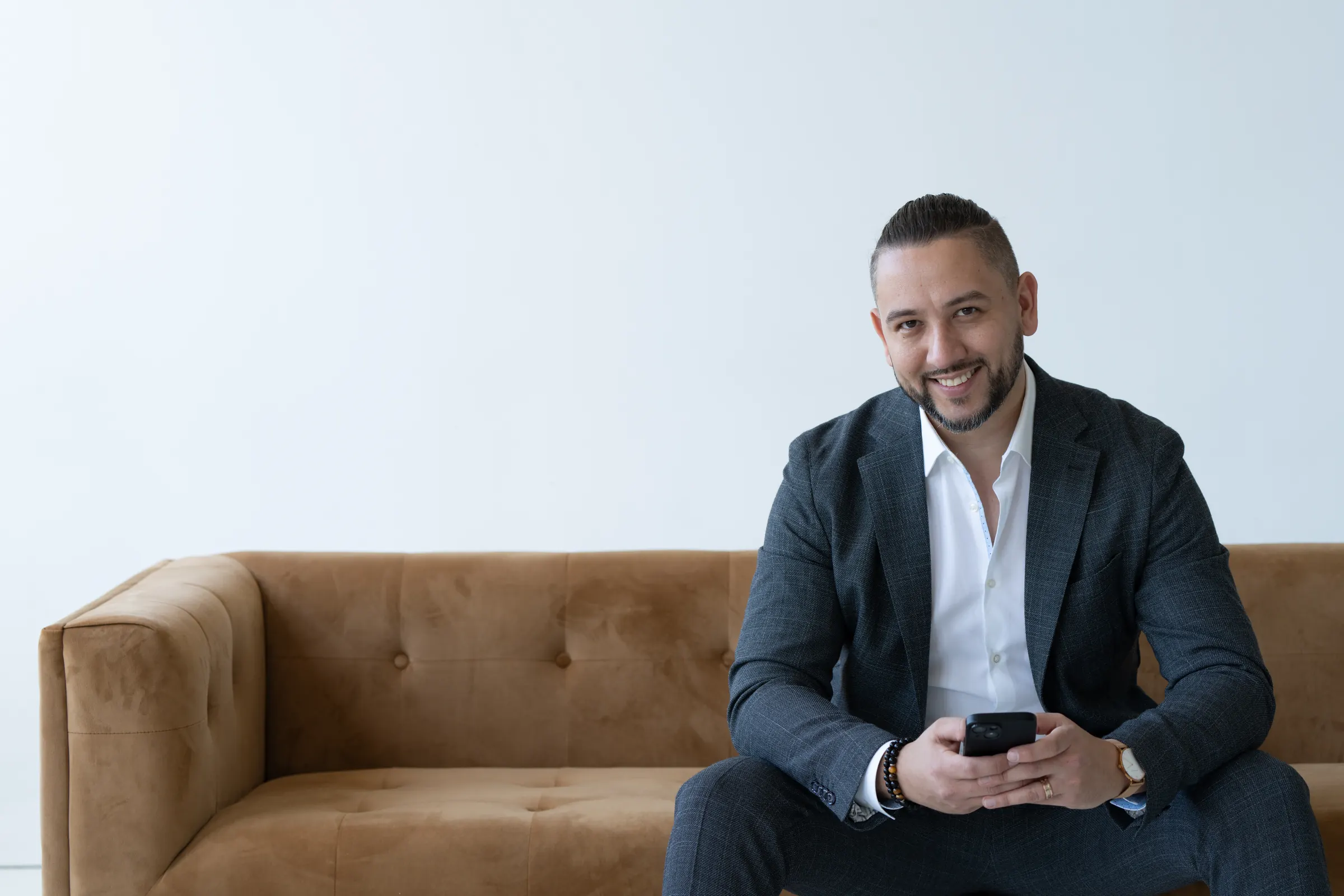 Alex Antsyferov, Durham Region real estate agent, seated on a sofa
