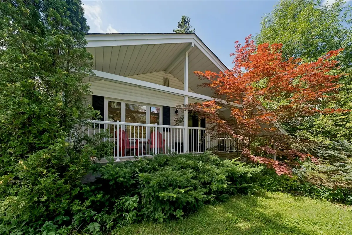Front of 20 Lyncroft Drive, a brick bungalow with a covered porch and red Japanese maple in Guildwood, Toronto